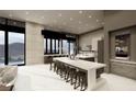 Modern kitchen with an island bar, marble floors, stainless steel appliances and mountain view at 563 Rock Peak Dr, Henderson, NV 89012