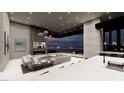 Living room with fireplace, television, modern furniture, and a gorgeous night view at 563 Rock Peak Dr, Henderson, NV 89012