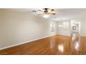 Spacious living area featuring beautiful wood floors, a ceiling fan, and ample natural light at 6076 Wheat Penny Ave, Las Vegas, NV 89122