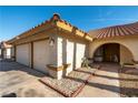 Well-kept single-story home featuring a two-car garage and charming front entrance with stone accents at 6509 Vicuna Dr, Las Vegas, NV 89146