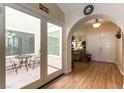 Inviting home foyer with wood floors that flow into the dining area and large sliding glass door to a patio at 6509 Vicuna Dr, Las Vegas, NV 89146