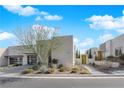 Modern house with well-maintained desert landscaping, a private walkway, and unique architectural design at 658 Falcon Summit Ct, Henderson, NV 89012