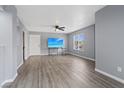 Spacious living room features wood-look floors, ceiling fan and large window at 6800 E Lake Mead Blvd # 1033, Las Vegas, NV 89156