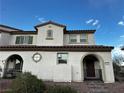 Beautiful townhouse featuring covered arches, desert landscaping, and a serene ambiance at 727 Pickled Pepper Pl, Henderson, NV 89011