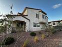 Inviting two-story home with desert landscaping, stucco exterior, and a tiled roof in a sunny neighborhood at 727 Pickled Pepper Pl, Henderson, NV 89011