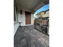 Charming tiled front porch with black metal railings and front door, offering a welcoming entry to the home at 727 Pickled Pepper Pl, Henderson, NV 89011