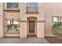 Welcoming front entrance featuring a classic wood door, decorative tile accents and a nicely paved walkway at 7270 Sheared Cliff Ln # 104, Las Vegas, NV 89149