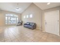Spacious living room with tiled floors, high ceilings, and large windows providing ample natural light at 7270 Sheared Cliff Ln # 104, Las Vegas, NV 89149