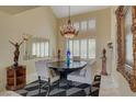 Elegant dining area featuring a chandelier, modern decor, and large window shutters at 7613 Hackensack Ct, Las Vegas, NV 89128