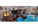 Cozy living room displaying an array of decorations, a large screen TV, and comfortable seating arrangement at 7885 W Flamingo Rd # 1127, Las Vegas, NV 89147