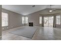 Bright living area with a fireplace, tile flooring, and sliding doors to the backyard at 8121 Heavenly Star Cir, Las Vegas, NV 89128