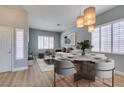 Bright dining area with pendant lighting, lots of natural light and light wood floors at 8232 Sedona Sunset Dr, Las Vegas, NV 89128