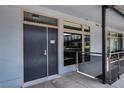 Modern building hallway with a unit entrance, windows with views, and contemporary design elements at 8925 W Flamingo Rd # 228, Las Vegas, NV 89147