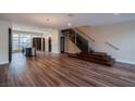 Modern living room featuring wood floors, an open layout, statement lighting, and a staircase at 8925 W Flamingo Rd # 228, Las Vegas, NV 89147