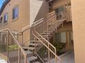Tan two-story home featuring stairs to the second floor with well-maintained landscaping at 8985 S Durango Dr # 2043, Las Vegas, NV 89113