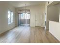 Bright living room featuring wood-look floors, a sliding glass door, and natural light at 8985 S Durango Dr # 2043, Las Vegas, NV 89113