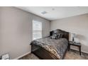 Cozy bedroom with a queen-sized bed, side table, and a window for natural light at 9050 W Tropicana Ave # 1080, Las Vegas, NV 89147