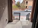 View from the front door of the property with a car parked on the street in front of the unit at 10067 Sand Key St, Las Vegas, NV 89178
