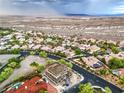 An aerial captures a residential area amid desert terrain, highlighting the neighborhood's layout and scenic mountain backdrop at 18 Placa De Rei Ct, Henderson, NV 89011