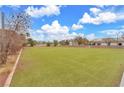 View of the spacious artificial turf field, surrounded by trees and landscaping, perfect for outdoor activities and relaxation at 2130 E Maule Ave, Las Vegas, NV 89119