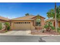 Charming single-story home with a well-manicured front yard and two-car garage at 228 Mchenry St, Las Vegas, NV 89144