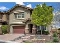 Charming two-story home boasts a well-manicured front yard, covered entry, and a two-car garage at 5742 Shadow Bend Dr, Las Vegas, NV 89135