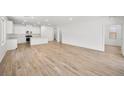 Bright, open-concept living space features wood-look flooring and natural light at 74 Via Montoro, Henderson, NV 89011