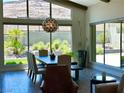 Bright dining room with large windows, modern lighting, and wood-look flooring at 10271 Meridian Hill Ave, Las Vegas, NV 89135