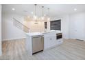 Open kitchen with island, stainless steel appliances, marble countertops, and pendant lighting at 10631 Sariah Skye Ave, Las Vegas, NV 89166