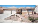 Charming single-story home with xeriscaping, desert plants, and a spacious two-car garage at 1072 Pennyfeather Rd, Henderson, NV 89015