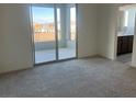 Carpeted main bedroom featuring sliding glass doors leading to a balcony and an attached bath at 12434 Parkscene Pl, Las Vegas, NV 89138