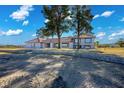 Spacious single-story house featuring large windows, a tile roof, and mature trees on a large lot at 1967 N Moapa Valley Blvd, Logandale, NV 89021