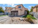 Charming two-story home with a two-car garage, low maintenance front yard, and desert landscaping at 2211 Arborwood Way, Las Vegas, NV 89142