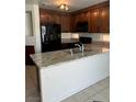 Kitchen featuring granite countertops, stainless steel appliances, and wooden cabinets at 2211 Arborwood Way, Las Vegas, NV 89142
