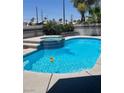 Sparkling pool with an inviting spa, lush landscaping, and a fun yellow duck float at 2211 Arborwood Way, Las Vegas, NV 89142