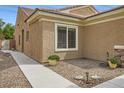 View of the side yard with manicured landscaping and a pathway to the front of the home at 2324 Willow Wren Dr, North Las Vegas, NV 89084