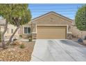 Attractive home featuring a two-car garage, desert landscaping, and a well-maintained exterior at 2324 Willow Wren Dr, North Las Vegas, NV 89084