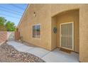Inviting home entrance with a charming front door, walkway, and desert landscaping at 2324 Willow Wren Dr, North Las Vegas, NV 89084