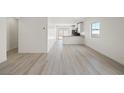 Bright living area with hardwood floors leading to the kitchen at 2618 Lily Point St, Las Vegas, NV 89156