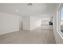 Bright living room with new hardwood flooring and open access to the kitchen at 2618 Lily Point St, Las Vegas, NV 89156