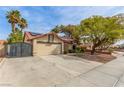Charming single-story home with a red tile roof, solar panels, desert landscaping, and a two-car garage at 2842 Mahogany Grove Ave, Henderson, NV 89074