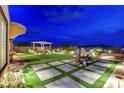 Expansive backyard with well-maintained lawn, covered seating area, and landscaped features, perfect for outdoor entertaining at 2913 Grande Arch St, Henderson, NV 89044