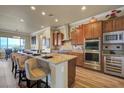 Modern kitchen with granite countertops, stainless steel appliances, and a breakfast bar with seating at 2913 Grande Arch St, Henderson, NV 89044