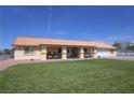 Charming single-story home with a covered porch, manicured lawn, and a terracotta-colored roof at 3110 National Ave, Pahrump, NV 89048