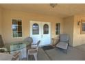Inviting front porch featuring a seating area with glass table and outdoor seating at 3110 National Ave, Pahrump, NV 89048