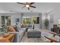 Bright living room featuring a comfortable gray sectional, stylish decor, and plenty of natural light at 3268 Grayson Lake Ct, Las Vegas, NV 89129