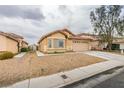 Charming single-story home with desert landscaping and a two-car garage offers curb appeal at 4417 Gracemont Ave, Las Vegas, NV 89139