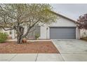 Beautiful single-story home with a two car garage and desert landscaping at 5012 Naff Ridge Dr, Las Vegas, NV 89131