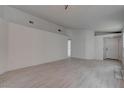Spacious living room with new wood flooring, fresh paint, and a neutral color palette at 5328 Walton Heath Ave, Las Vegas, NV 89142