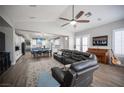 Open-concept living room with vaulted ceilings, wood floors, and a view of the kitchen and dining area at 5815 Pristine Falls Ave, Las Vegas, NV 89131